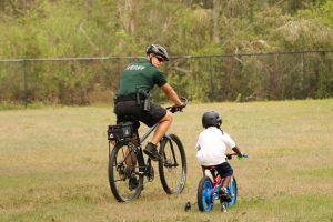 Sheriff rides bike with child